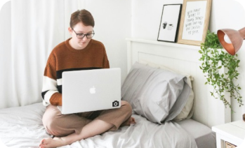 person on laptop in bed