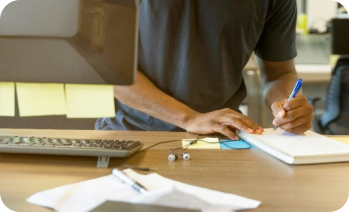 man writing on a notepad